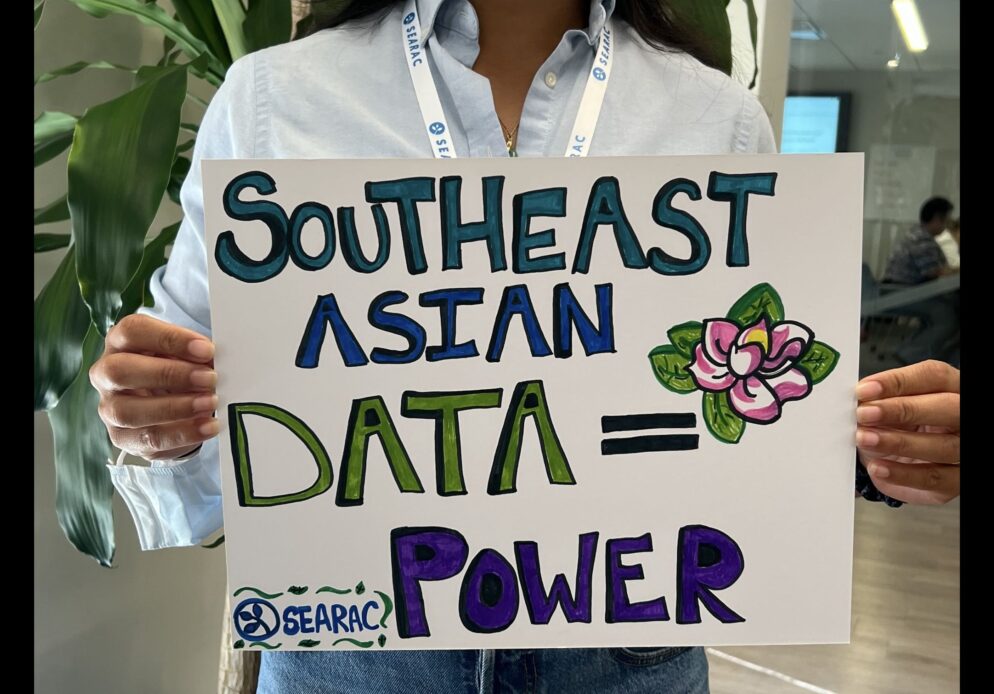 person holds a poster that says Southeast Asian Data = Power